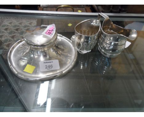 A silver capstan inkwell, of typical form, Birmingham 1936, 15 cm (5 3/4 in) diameter, together with a small George III style