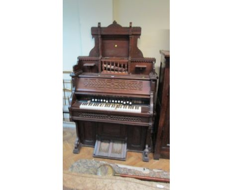 A 19th century walnut cased Bell & Co harmonium, with fretted and incised decoration