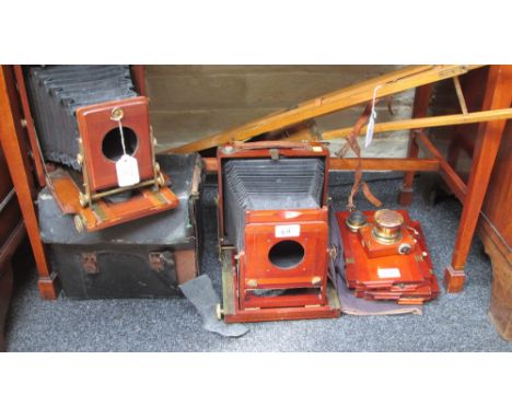 A Thornton Pickard 'Imperial' half plate mahogany and brass bellows camera, and two lenses, tripod, film cartridges, etc, tog