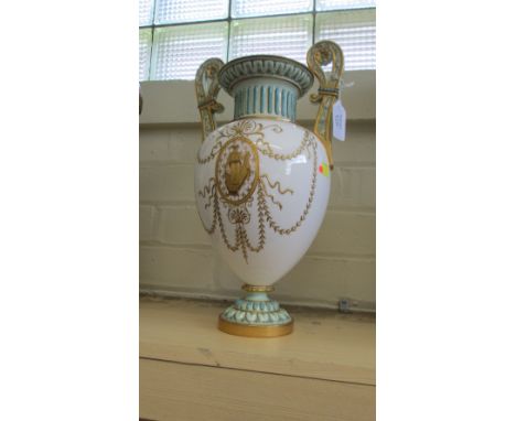 An Edwardian Royal Worcester porcelain two handle 'Grecian' style vase, the white body with raised gilt swags and oval panels