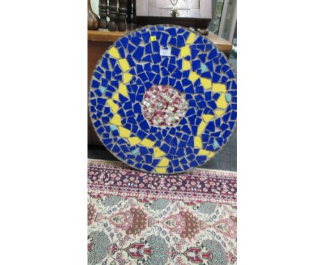 A circular wooden and ceramic mosaic tiled table top, 59 cm diameter