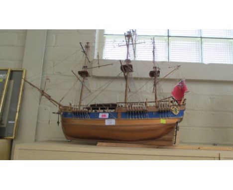 A fully rigged wooden scale model of a man-o-war, flying the red ensign and cross of St George, 82 cm (32 in)