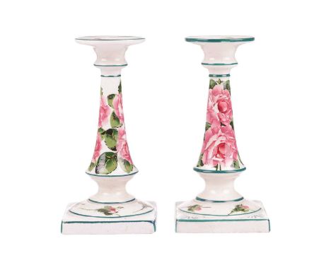 A pair of Wemyss pottery candlesticks, early 20th century, of inverted tapering cylindrical form on square bases, painted wit