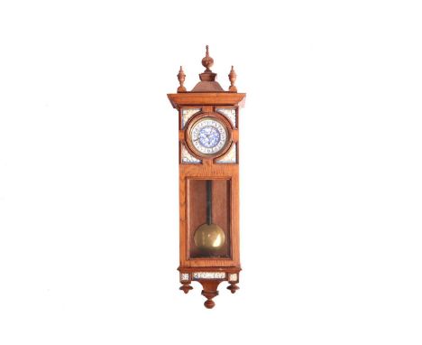 An early 20th century Austrian Aesthetic Movement single weight regulator with an oak case, the turned finials and caddy top 