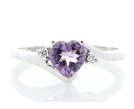 An intricate heart shaped amethyst is set between two round brilliant cut diamonds in this 9 carat white gold ring. This uniq