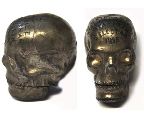 An Edwardian base metal novelty vesta case in the form of a skull, inscribed and dated 1905.