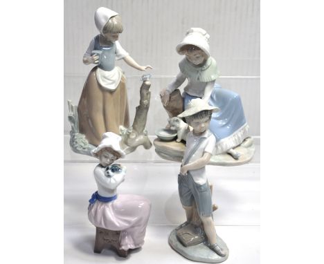 Four Nao figurines; a boy with a slingshot,a lady with a cat, a girl approaching a butterfly and a girl holding a dog (4).