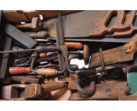 A quantity of assorted vintage hand tools to include saws, a brace and bit etc.