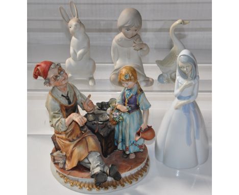 A Capodimonte figure group of an elderly man and a young girl, four Spanish style Nao figures, a young lady, a young boy, a r