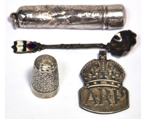 A hallmarked silver thimble, Charles Horner, a hallmarked silver cap badge, a cigarette holder and an enamel and white metal 