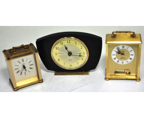 Two reproduction brass carriage clocks and a mid 20th century wooden mantel clock on a brass stand (3).