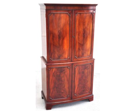 A reproduction flame mahogany drinks cabinet comprising two double internal sections with internal lighting system, width 78c