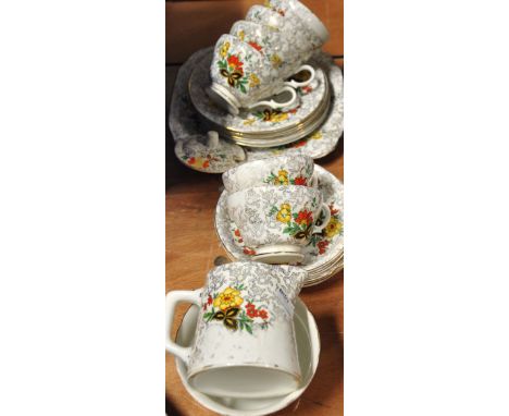 A Shelley floral and gilt heightened tea services to include cups, saucers and plates.