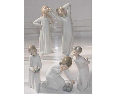 Five Lladro figures of children in nightgowns, one holding a candle, one holding a pair of slippers (5).
