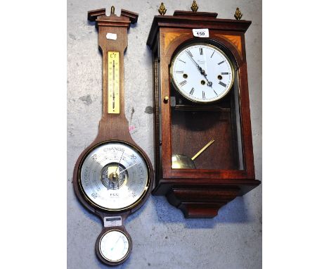 A reproduction Edwardian style Comitti of London wall clock, the top with artichoke finials and a reproduction wall barometer