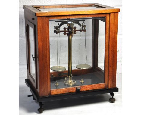 A cased set of scales with brass weights