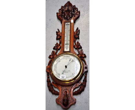 An early 20th century oak barometer by Chadburn & Son of Liverpool with foliate carved decoration.
