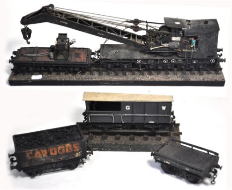 A scratch built O gauge model of a railway crane on a section of track, a similar model of a Great Western break van also on 
