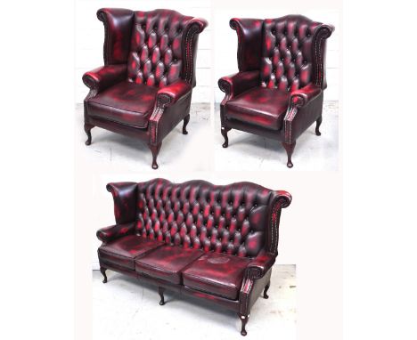 A 20th century reproduction Chesterfield style burgundy leather suite on cabroile legs, comprising sofa, width approx 185cm, 