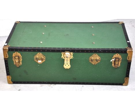 A large green metal and brass bound travel trunk, 100 x 33cm.