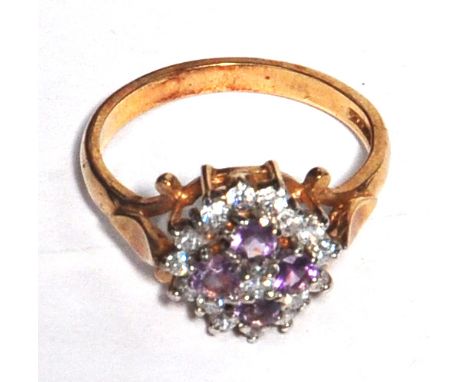 A 9ct gold floral ring set with red and white stones size O, approx weight 3.6g.