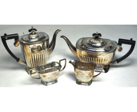 An Elizabeth II hallmarked silver four piece tea service to include teapot, length 30cm, hot water jug, jug and sugar basin, 