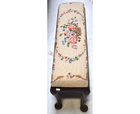A walnut tapestry covered low stool on cabriole legs.