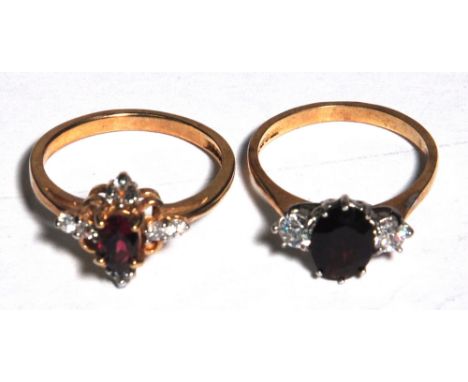 Two 9ct gold ladies dress rings one set with a central red stone and white stone either side size N, one set with small ruby 