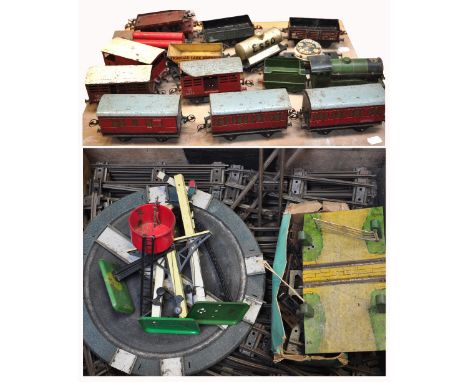 An ammunition case containing a good quantity of early Hornby O gauge rolling stock, carriages, track and accessories, includ