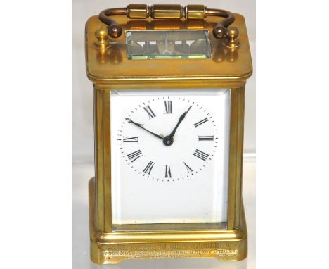 A 19th century brass cased carriage clock, white dial set with Roman numerals, inscribed "Presented to Miss Thomas by the Mot