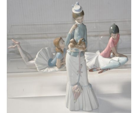 Two Lladro figurines of ballerinas and a Lladro figurine of a lady holding a dog and an umbrella (3).