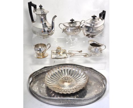 A plated gallery tray, a plated four piece tea service, spoons, shell dish and a candle holder etc.