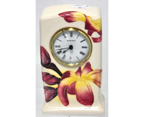 A Moorcroft "Magnolia" design mantel clock, height 16cm.