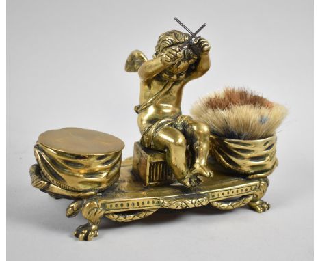 A Late 19th Century French Brass Desktop Inkstand, Having Centre Seated Cherub Holding Drumsticks and Flanked by Two Draped D