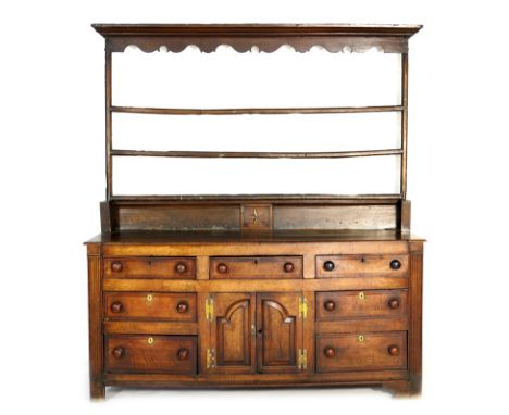 George II oak and mahogany enclosed dresser, circa 1740-60 and later, having a later pine open plate rack with cornice and sh