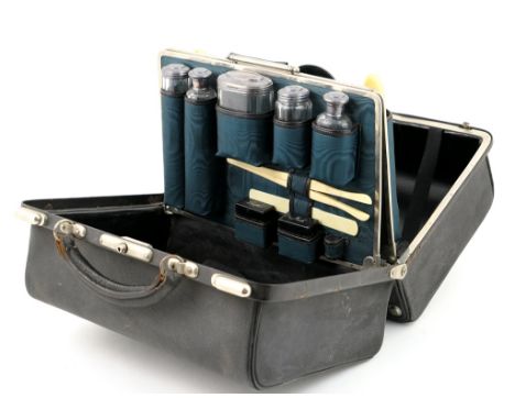 Late Victorian fitted leather vanity case, circa 1895, having a full complement of silver capped bottles, hallmarked Birmingh