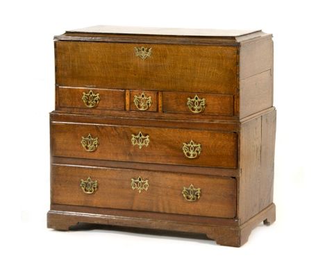 Queen Anne oak mule chest, circa 1710, having a lift up caddy top over three small drawers, the centre drawer enclosing a sec