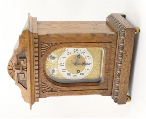 German oak cased mantel clock, circa 1900, architectural case enclosing an arched brass dial with silvered chapter ring, Arab