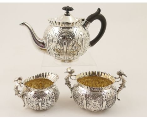 Victorian silver three piece tea service, by Edward Hutton, London 1892, of unusual design with fairies adorning the sugar bo