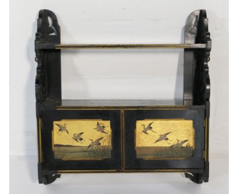 Victorian Aesthetic period wall cabinet, circa 1885, having an ebonised finish with two painted panel cupboard doors featurin