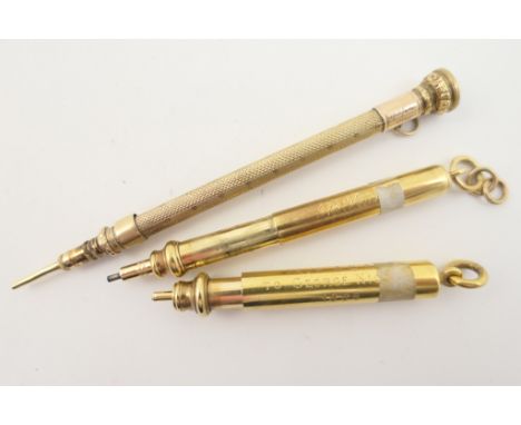 Three gold coloured propelling pencils comprising a Sampson Mordan & Co. example; another with engine turned decoration, insc