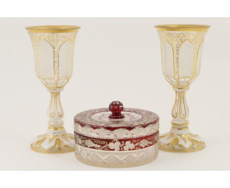 Pair of Bohemian white overlay and gilded glass goblets, late 19th Century, trumpet shaped bowl worked with lappet shaped pan