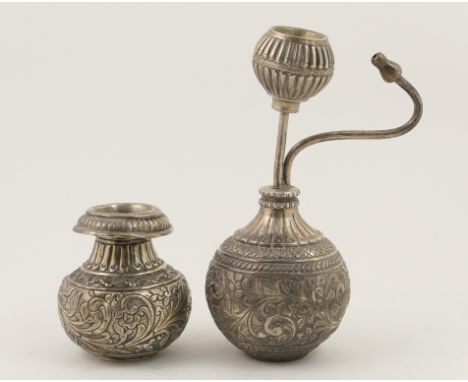 Indian white metal infuser, bottle form with mouth piece and  scrolled foliate engraving, 21cm; also an Indian white metal fl