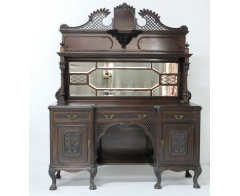 Victorian mahogany breakfront mirror back sideboard, circa 1890, carved trellis swan neck pediment with central plinth over a