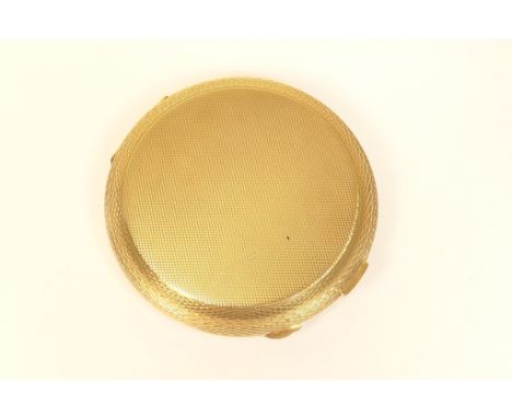 9ct gold compact, London 1966, engine turned circular form, 77mm diameter, weight of weighable gold approx. 79.8g