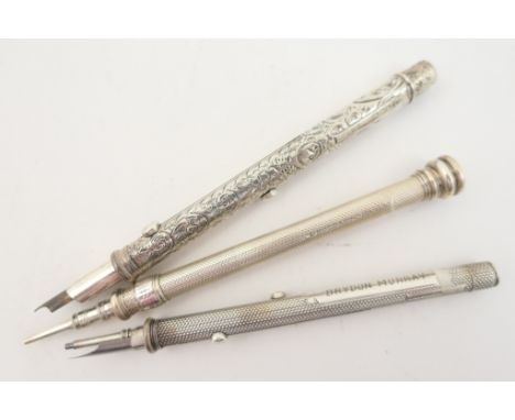 Three Sampson Mordan silver propelling pencils comprising an engine turned example with vacant pale agate seal top, London 18