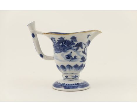 Chinese Export blue and white milk jug, late 18th Century, helmet shaped and decorated with a lakeside landscape, height 14cm