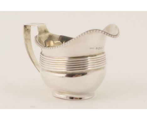 George III silver milk jug, by William Hall, London 1806, helmet shaped with gadrooned border and reeded band, initialled to 