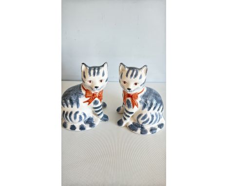Pair of Rye Pottery cat figurines, made in England, featuring blue and white glaze with orange bows.