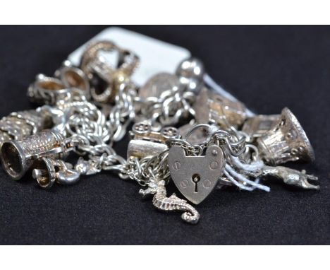 Silver charm bracelet with silver and white metal charms, gross weight 65g 